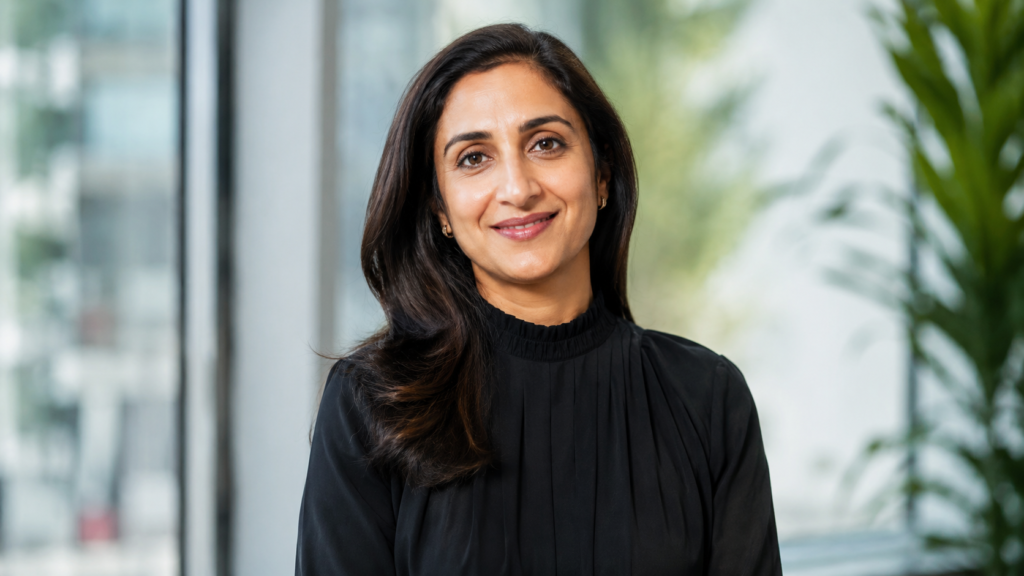 Kavya Pichai in a professional portrait wearing a modest black high-neck outfit.